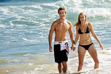 A couple taking a stroll on the beach