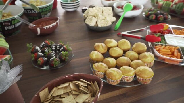 Pan of Party Smorgasbord of Football Theme Snacks and Food on Table for Super Bowl