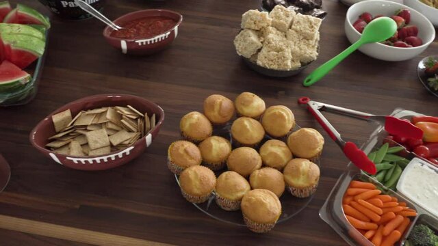 Pan of Party Table of Super Bowl Theme Food and Snacks on Table for Football