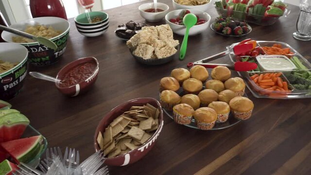 Huge Smorgasbord of Football Theme Snacks and Food on Table for Sport Celebration