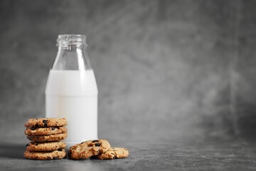 Baked chocolate cookies and Milk Bottles on the loft background.