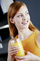 Woman holding a glass of orange juice