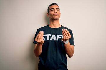 Young handsome african american worker man wearing staff uniform over white background doing money gesture with hands, asking for salary payment, millionaire business