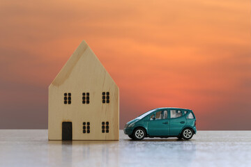 Wooden house and toy cars on the floor.
