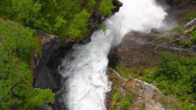 Aerial view of a river bird view following the path and revealing a waterfall at the end