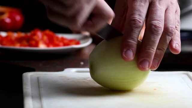 Chopping an onion in fine brunoise. Close shot.