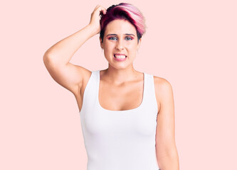Fototapeta premium Young beautiful woman with pink hair wearing casual clothes confuse and wonder about question. uncertain with doubt, thinking with hand on head. pensive concept.
