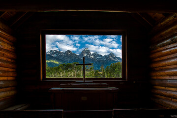 View of the mountains in Grand Teton National Park through a small chapel in the park