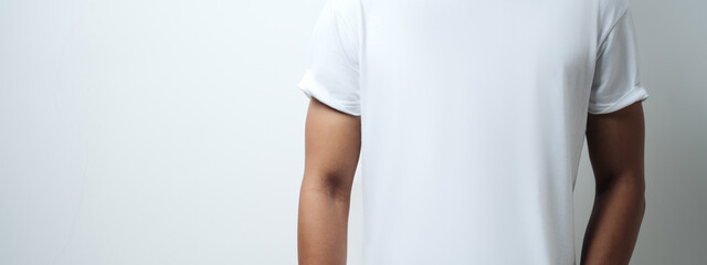 man in white blank t-shirt, empty wall, studio close-up, casual style. Wide screen, panoramic