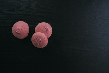pink meringues on a dark wooden background