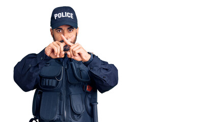 Young hispanic man wearing police uniform rejection expression crossing fingers doing negative sign