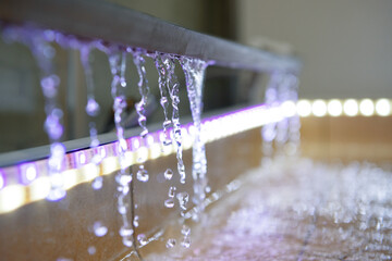 Water is drained from the tray to the floor of the shower. Multi-colored LED backlight - obrazy, fototapety, plakaty