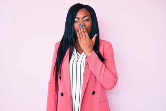 Young african american woman wearing business clothes bored yawning tired covering mouth with hand. restless and sleepiness.