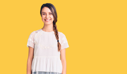 Young beautiful girl wearing casual t shirt looking positive and happy standing and smiling with a confident smile showing teeth