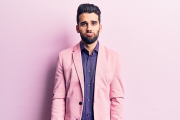 Young handsome man with beard wearing elegant jacket depressed and worry for distress, crying angry and afraid. sad expression.