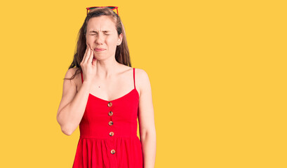 Young beautiful blonde woman wearing casual dress touching mouth with hand with painful expression because of toothache or dental illness on teeth. dentist