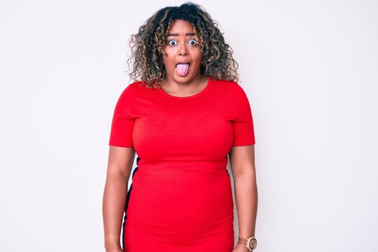 Young african american plus size woman wearing casual clothes sticking tongue out happy with funny expression. emotion concept.