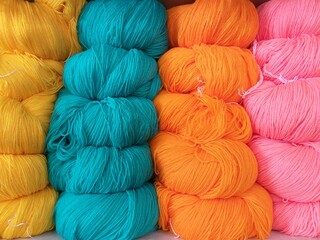 Stack of colorful knitting wool, Knitting is a method by which yarn is manipulated to create a textile or fabric, often used in many types of garments