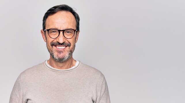 Middle Age Handsome Man Wearing Casual Sweater And Glasses Over Isolated White Background With A Happy And Cool Smile On Face. Lucky Person.