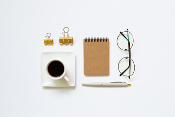 Notebook, pen, cup of coffee, glasses, clip on white background. Work and study place. flat lay, top view, copy space