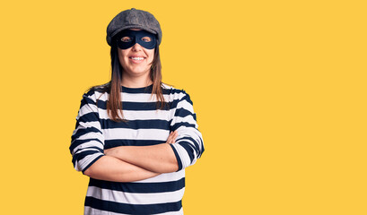 Young beautiful brunette woman wearing burglar mask happy face smiling with crossed arms looking at the camera. positive person.