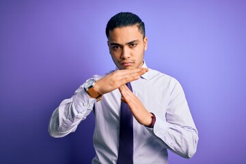 Young brazilian businessman wearing elegant tie standing over isolated purple background Doing time...