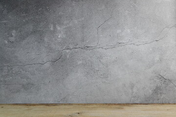 the old crack grey cement wall and wooden table in the house