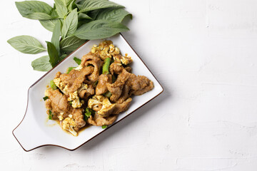 Stir Fried Pork with Green Curry Paste in a White Background