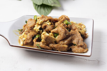 Stir Fried Pork with Green Curry Paste in a White Background