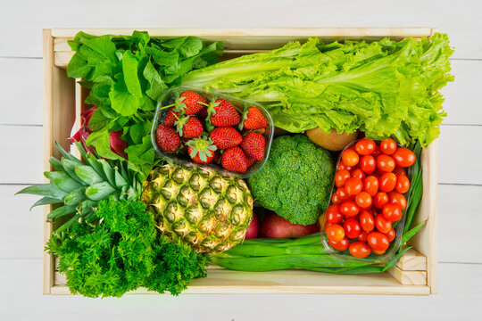 Variety vegetables and fruits in wooden box