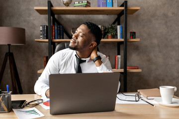 Handsome african business man tired after work in modern office