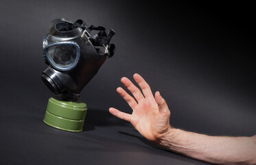 Man in room, trying to reach for vintage gasmask - Green filter