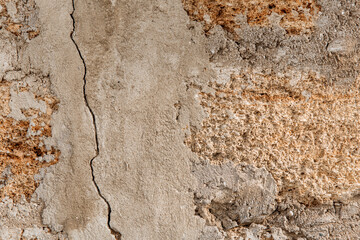Rough texture of a brick wall made of shells. There is a crack in the middle of the wall.