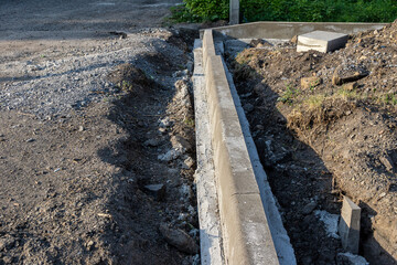 installation of a border block in the process of landscaping, selective focus