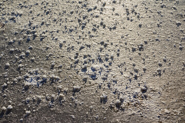 Snow or ice texture or background outdoors in a winter day. Nature landscape with frozen water on a lake or river in the cold and sun.