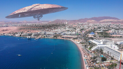 Alien ufo Saucers over Large Vacation City desert near sea,Aerial
Red sea, Eilat city, Israel Drone view with visual effect Elements, summer
 - obrazy, fototapety, plakaty