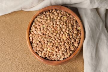Raw lentils in bowl on table