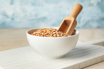 Raw lentils in bowl on table