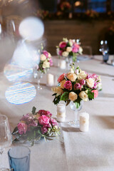 Beautifully decorated table setting at a wedding reception, birthday or Valentine's day. Floral decorations for the holiday.