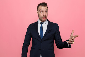 surprised elegant man looking to side and gesticulating