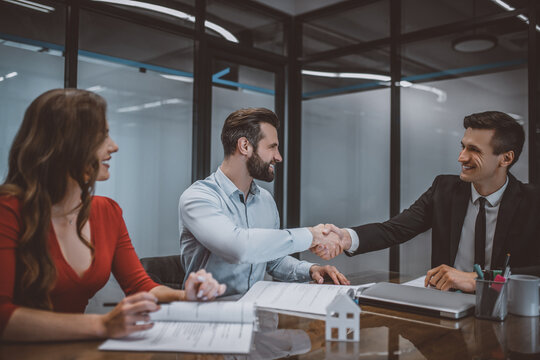 Young couple buying a new apartment at the sellers office