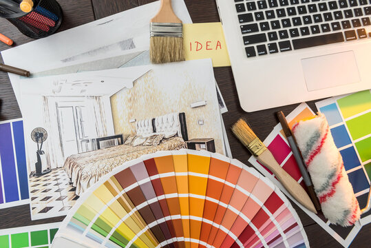 Color  palette for design home renovation. Apartaments sketch with sampler laptop and brush at desk