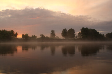 Morning landscape on the Sejm river, Ukraine, fog over the water and sunrise