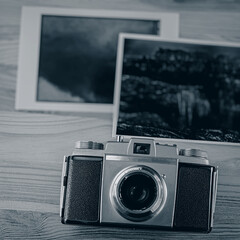 Vintage analog camera and old photographic prints.
