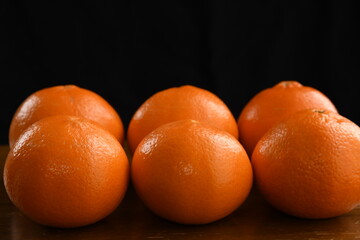 Mandarin orange fruits on black background