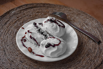 Sweet snack for breakfast - white marshmallows on a wooden table