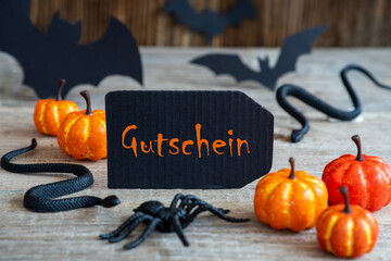 Black Label With German Text Gutschein Means Voucher. Scary Halloween Decoration Like Bat, Snake...