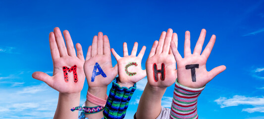 Children Hands Building Colorful German Word Macht Means Power. Blue Sky As Background