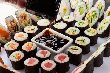 Various kinds of sushi roll set served on cutting board. Japanese food