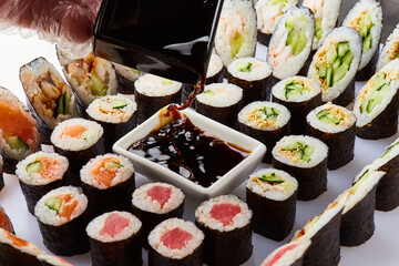 Various kinds of sushi roll set served on cutting board. Japanese food